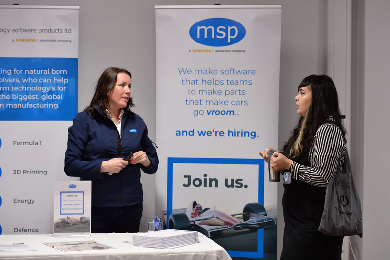 Marianne Whitfield talking to a TechUpWomen participant in front of an MSP careers stand